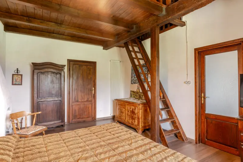 Camera con soppalco e scala in legno